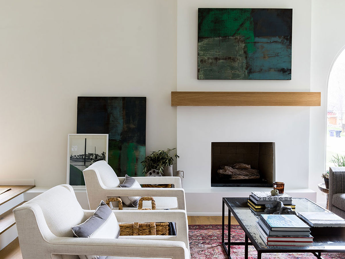 Modern living room featuring a fireplace with wood mantel.