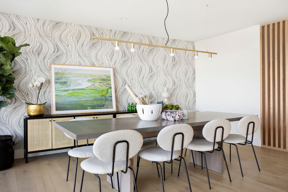 Clean dining room remodel with wood light colored accents and modern wallpaper.